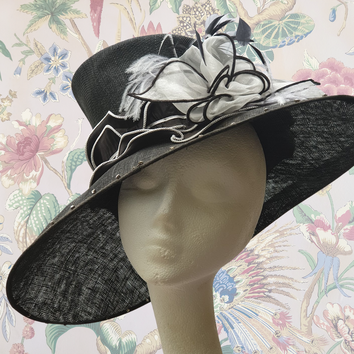 Mannequin head wearing a black & white re-loved special occasion hat